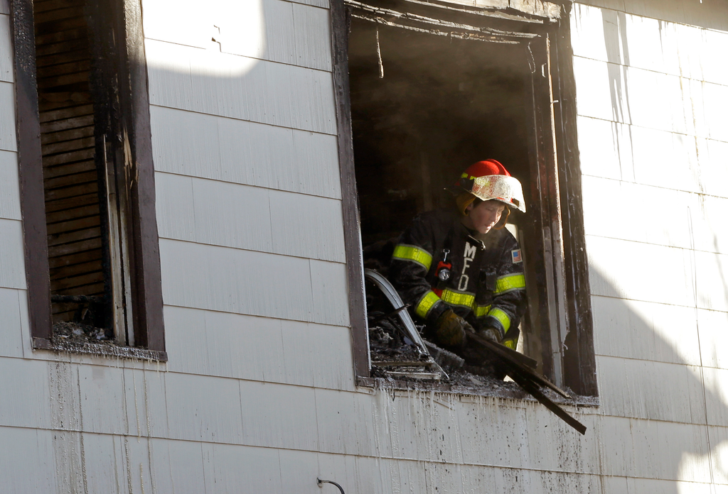 Minneapolis firefighters respond to a fire at a duplex in Minneapolis, on Friday, Feb. 14, 2014.