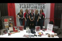The Firefighter Wife volunteers posed for a quick group photo in their booth at Firehouse World in San Diego last month.
