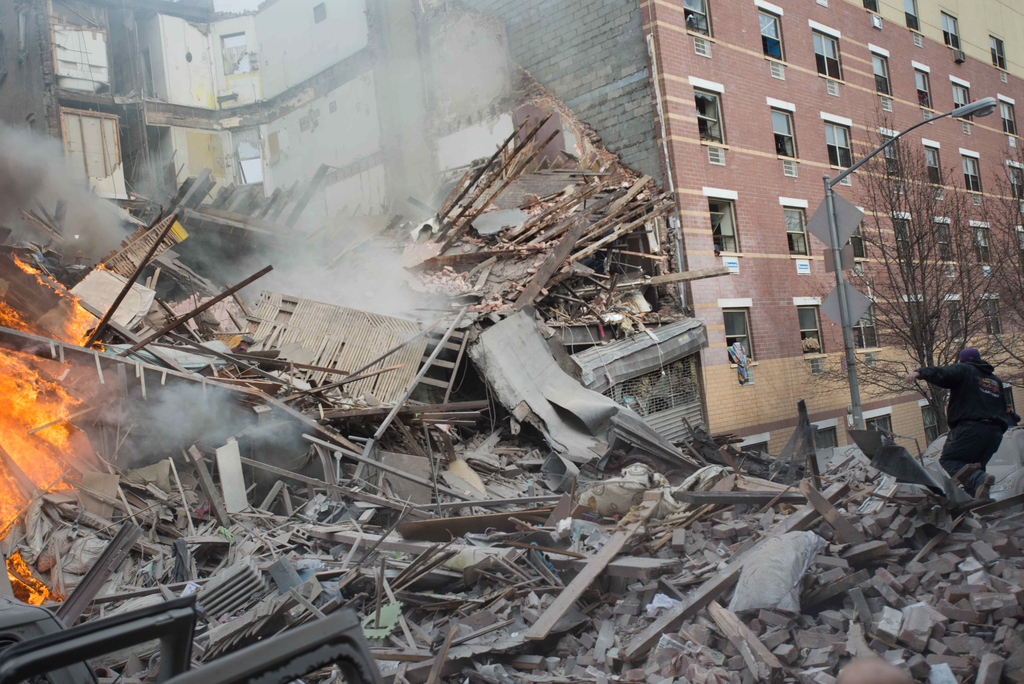 Emergency workers respond to the scene of an explosion that leveled two apartment buildings in the East Harlem neighborhood of New York, Wednesday, March 12, 2014. Con Edison spokesman Bob McGee says a resident from a building adjacent to the two that collapsed reported that he smelled gas inside his apartment, but thought the odor could be coming from outside.