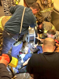 Crews work to extricate boy's hand from escalator. Crews work to extricate boy's hand from escalator.