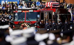 The casket of Firefighter Michael Kennedy moves through the street. The casket of Firefighter Michael Kennedy moves through the street.