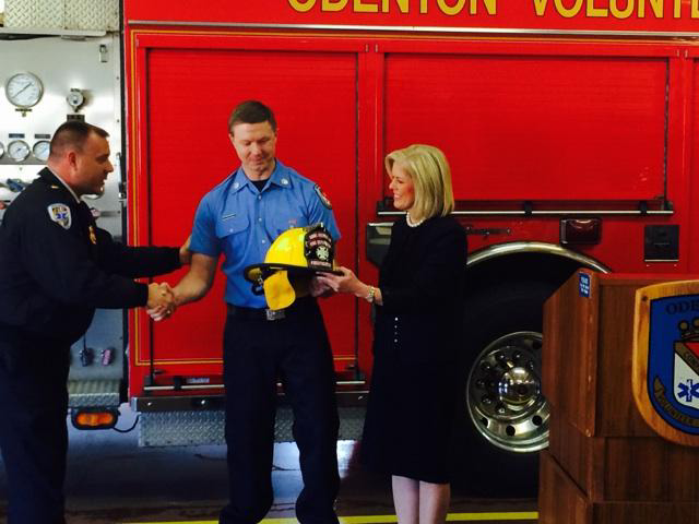William Fisher, center, was welcomed back to Odenton Vol. Fire Co. by Anne Arundel County Executive Laura Neuman.