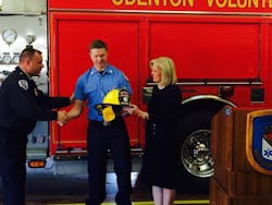William Fisher, center, was welcomed back to Odenton Vol. Fire Co. by Anne Arundel County Executive Laura Neuman. William Fisher, center, was welcomed back to Odenton Vol. Fire Co. by Anne Arundel County Executive Laura Neuman.
