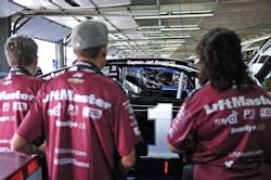 Members of the LiftMaster crew look at Jaime McMurray&apos;s car where Capt. Jeffrey Bowen&apos;s name added above the passenger door.