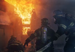 It is easy to identify the officer in this photo. He is above the engine crew to better keep an eye on the situation and is not only looking out for the safety of his crew, and that of the truck company opening the door, but moving them forward to attack the fire as well. It is easy to identify the officer in this photo. He is above the engine crew to better keep an eye on the situation and is not only looking out for the safety of his crew, and that of the truck company opening the door, but moving them forward to attack the fire as well.