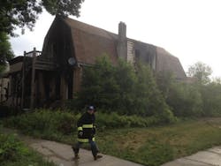 A Chicago fire officials leaves the scene of the fatal fire Sunday.