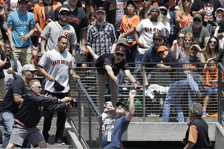 Rob Winner, a captain with San Rafael Fire, caught the home run ball during Sunday's Rockies and Giants game.