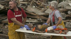 Rescue personnel tend to a young tornado victim in Pilger, Neb., Monday, June 16, 2014. A hospital spokeswoman says at least one person is dead and at least 16 more are in critical condition after two massive tornadoes swept through northeast Nebraska. AP Photo/Mark &apos;Storm&apos; Farnik