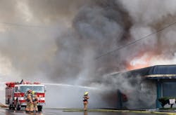 Crews operate defensively on the Alpha side of the furniture store with a monitor from Roseburg Engine 1332. Crews operate defensively on the Alpha side of the furniture store with a monitor from Roseburg Engine 1332.