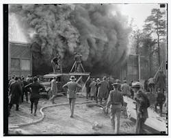 This undated photo shows a Hearst Metrotone News crew filming a silent newsreel featuring a building fire. The company was renamed News of the Day in 1916. It is interesting to note the wooden platform being used by one cameraman. It is not clear whether the fire was staged. This undated photo shows a Hearst Metrotone News crew filming a silent newsreel featuring a building fire. The company was renamed News of the Day in 1916. It is interesting to note the wooden platform being used by one cameraman. It is not clear whether the fire was staged.