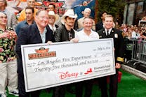 Director, John Lasseter; singer Brad Paisley; Vice President Brand Marketing, Fireman&apos;s Fund Insurance Company, Paul Fuegner; and Los Angeles Assistant Fire Chief Matthews present a check for $25,000 to the Los Angeles Fire Department as part of Fireman&rsquo;s Fund&rsquo;s Heritage Program, supporting firefighters for safer communities at the Disney premiere of Planes: Fire &amp; Rescue Tuesday, July 15 at the El Capitan Theater in Hollywood.