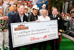 Director, John Lasseter; singer Brad Paisley; Vice President Brand Marketing, Fireman&apos;s Fund Insurance Company, Paul Fuegner; and Los Angeles Assistant Fire Chief Matthews present a check for $25,000 to the Los Angeles Fire Department as part of Fireman&rsquo;s Fund&rsquo;s Heritage Program, supporting firefighters for safer communities at the Disney premiere of Planes: Fire &amp; Rescue Tuesday, July 15 at the El Capitan Theater in Hollywood.
