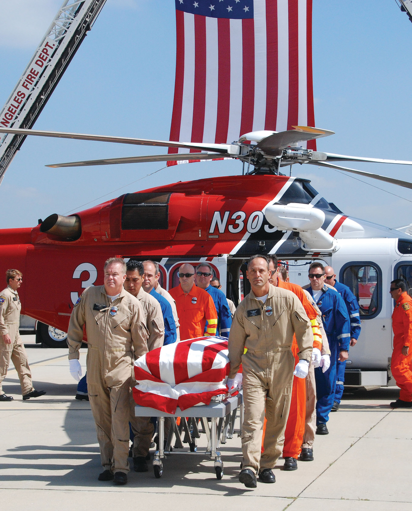 Flight crew members escort the body of LAFD Pilot/Paramedic Brian Lee, who died in an off-duty plane crash.