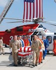 Flight crew members escort the body of LAFD Pilot/Paramedic Brian Lee, who died in an off-duty plane crash.