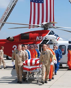 Flight crew members escort the body of LAFD Pilot/Paramedic Brian Lee, who died in an off-duty plane crash.