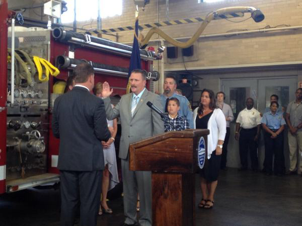 New Boston Fire Commissioner Joseph E. Finn (center) is sworn in by Boston Mayor Marty Walsh.