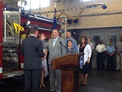New Boston Fire Commissioner Joseph E. Finn (center) is sworn in by Boston Mayor Marty Walsh.