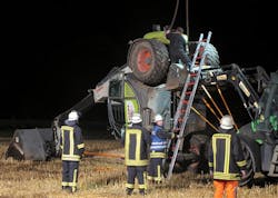 In this picture taken late Tuesday, July 29, 2014, firefighters try to set up a mechanical digger on a field near Isselburg, western Germany. German authorities say a man was killed and several others were injured when the digger tipped over and hit them during a so-called Cod Water Challenge.