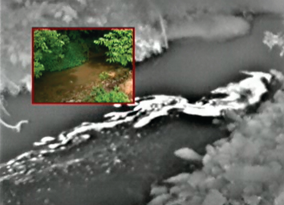 Photo 1. A fluid spill is visible on the surface of water.