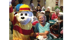 Giving talks to senior citizens and other community groups during Fire Prevention Week is a good way to spread your fire safety message. Here, Sparky the Fire Dog lends a hand.