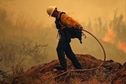 A firefighter battles the Mills Canyon Fire near Entiat in Chelan County, Wash., on July 10 as hot, dry weather blankets the state and has fire crews ready for action.