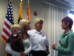 Medic Beth Honaker holds her son while talking with her mother, Chief Denise Pouget and Cathy Hedrick with the NFFF.