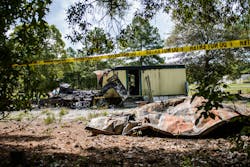 This Saturday, Aug. 30, 2014 photo shows the burned remains of a mobile home in Garland, N.C. An early Saturday fire killed six people inside, authorities said.