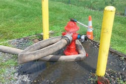 Photo 5: It is obvious the candidate understood the concept of wrapping the hydrant, but there might have been some confusion during the transition process in making the connection. These kinks in the supply hose would seriously hamper actual suppression efforts on the fireground.