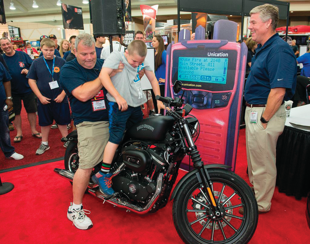 Frank Hrbek Jr. (with his son, Frank III) won the Harley-Davidson giveaway from Unification at Firehouse Expo in Baltimore.