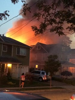 Flames engulf a structure in Port Washington, N.Y., Tuesday night.