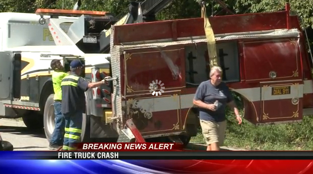 Workers clean up the scene after the Milton fire engine crashed Friday.