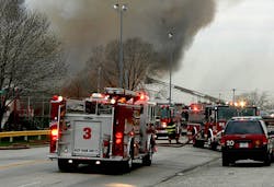 Apparatus, especially engines, arriving on the scene of multiple alarms, should consider backing to better position themselves if they have to go to work. In this instance, since the engine in the foreground did not lay a supply line, it is in a relatively useless position if they are ordered to provide additional lines without a lot of additional maneuvering. The engine right behind it has backed in, and will be able to quickly stretch lines if needed.
