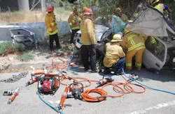 Three young adults were trapped when the SUV in which they were riding struck a tree in the Newhall Pass
