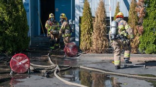 Firefighters remove pets from the fire scene in Beaverton.