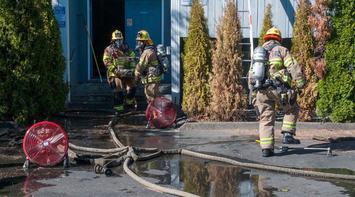 Firefighters remove pets from the fire scene in Beaverton.