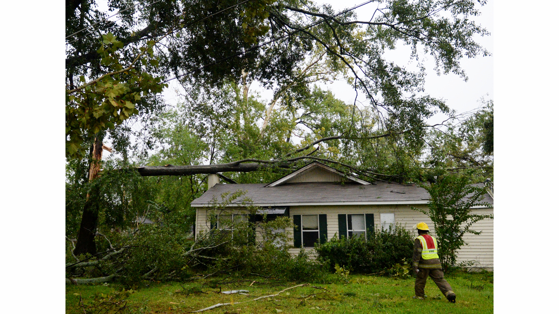 A firefighter checks for victims following a storm.