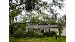 A firefighter checks for victims following a storm. A firefighter checks for victims following a storm.