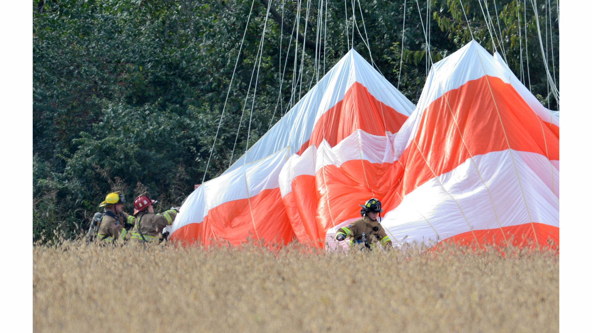 Firefighters respond to a mid-air collision between an airplane and a helicopter near the Frederick Municipal Airport Thursday, Oct. 23, 2014, in Frederick, Md.