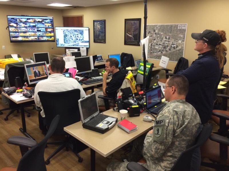 Members of the Unified Command in Clayton monitor as the announcement takes place.