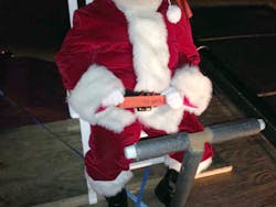 When Santa rode a fire truck during the 2014 Christmas parade, he was seated and belted, thanks to Dr. Burton Clark and the Oak Ridge Fire Department.