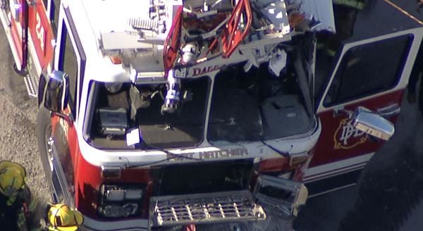 The ladder truck was en route to a fire when it collided with a cement truck.