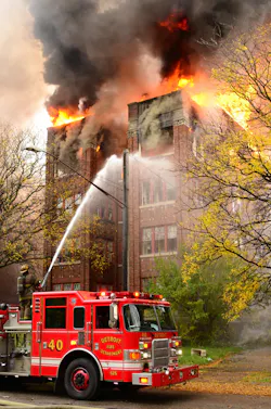 Engine 40 operates its monitor on the A/D corner of the heavily involved vacant apartment building.
