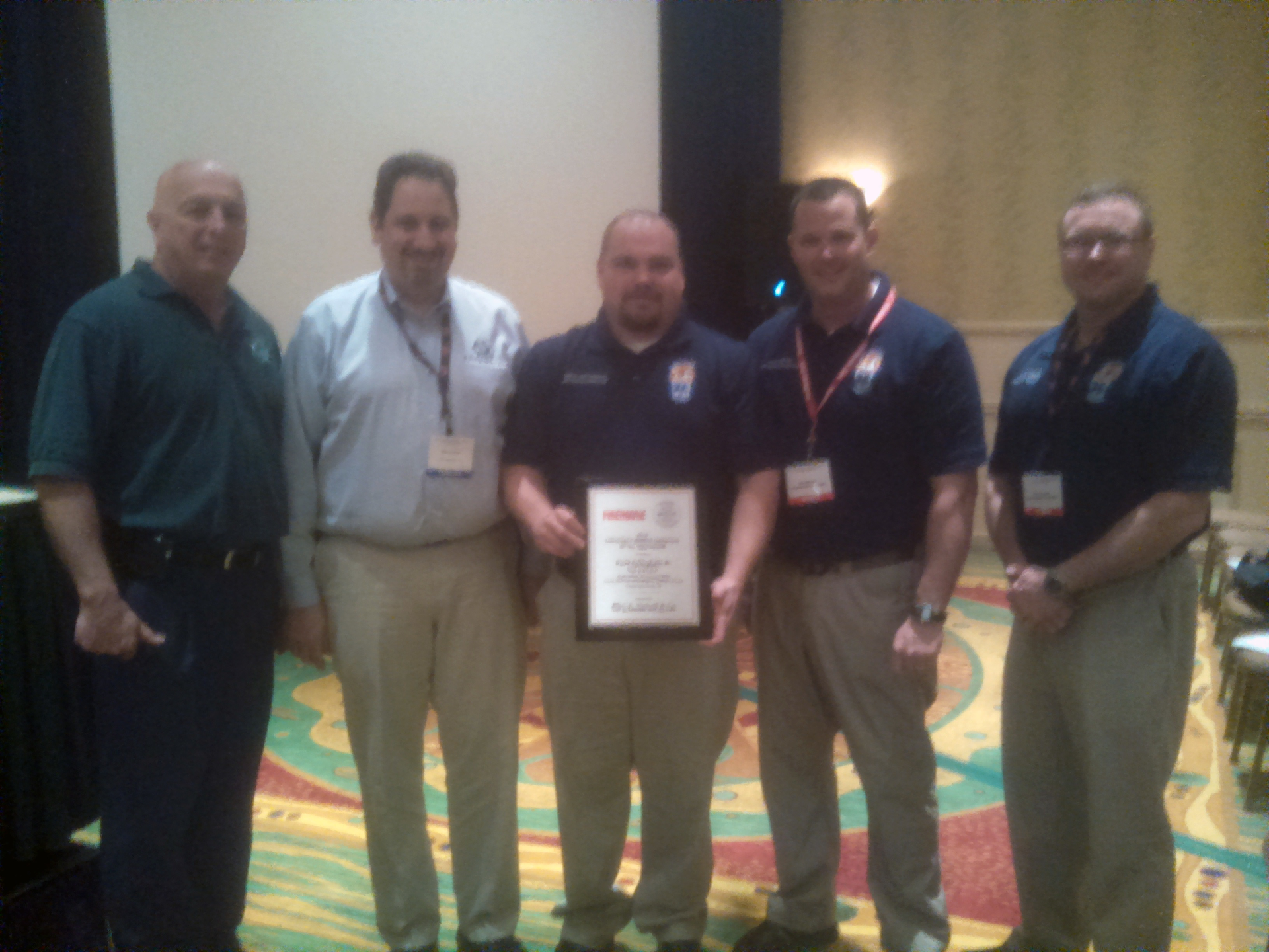 The EVT of The Year Award was presented to David Cottingham, center. He was flanked by (from left to right FDSOA Executive Director Rich Marinucci, Pete Sremac, commercial market manager for C.E. Niehoff & Co., , Lt. Mike Martell, and Capt. David Farmer.