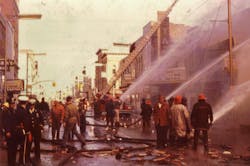 Firefighters and volunteers apply water to the buildings west of the State Theater to prevent spread farther to the east. All buildings on main between 5th and 6th avenues west of the theater were destroyed. Firefighters and volunteers apply water to the buildings west of the State Theater to prevent spread farther to the east. All buildings on main between 5th and 6th avenues west of the theater were destroyed.