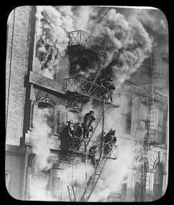 NEW YORK CITY: FEB. 19, 1915 –Two traffic police officers noticed a fire at West Broadway and Warren Street in lower Manhattan and pulled a nearby alarm box, then raced into the five-story brick building to warn the occupants. NEW YORK CITY: FEB. 19, 1915 –Two traffic police officers noticed a fire at West Broadway and Warren Street in lower Manhattan and pulled a nearby alarm box, then raced into the five-story brick building to warn the occupants.