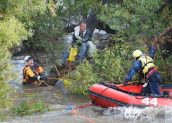 LAFD swift water rescue team members prepare to rescue a man stranded by high water in the Los Angeles River. The man was taken ashore on a raft and taken to a hospital with mild hypothermia. His wife was rescued an hour later and was in fair condition.