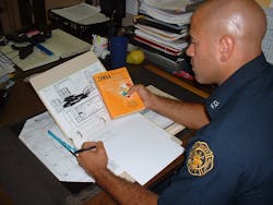 A student practices for a potential hazardous material scenario. A student practices for a potential hazardous material scenario.