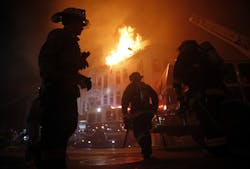San Francisco Fire Department members fight a four-alarm fire at 22nd and Mission Street in San Francisco, Calif., on Wednesday, Jan. 28, 2015.