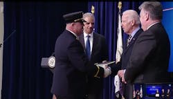 Former Bellmore Fire Chief John Curley is congratulated by Vice President Joe Biden during a White House ceremony.