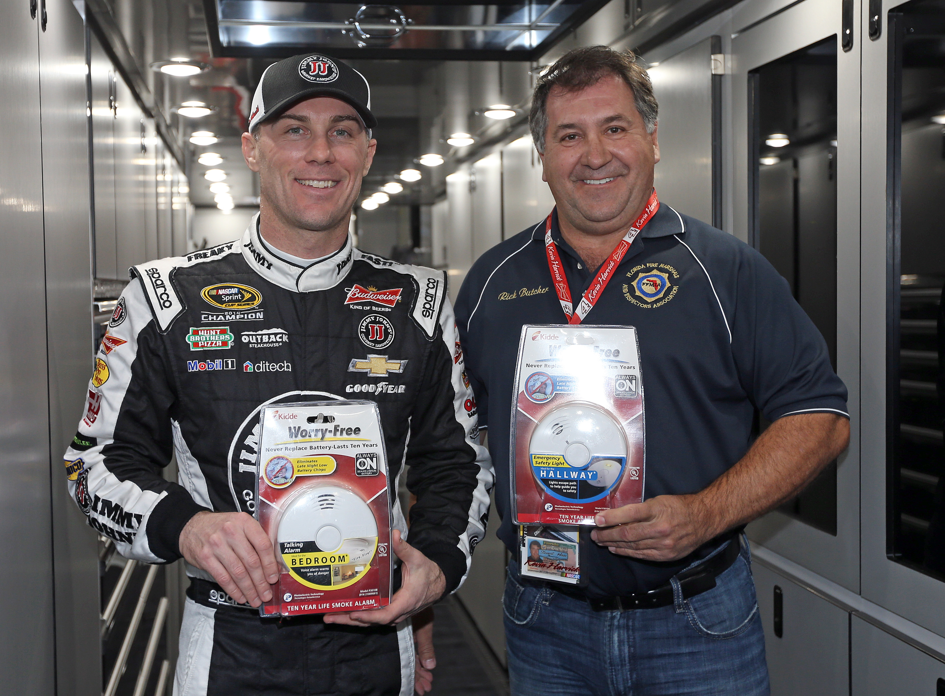 Kevin Harvick (left) makes donation of 250 Kidde smoke alarms to Rick Butcher, president of the Florida Fire Marshals and Inspectors Association.